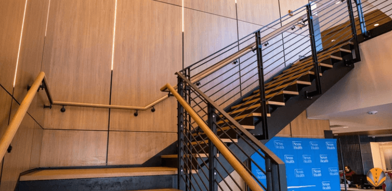 An image of wooden handrails in a Healthcare center.