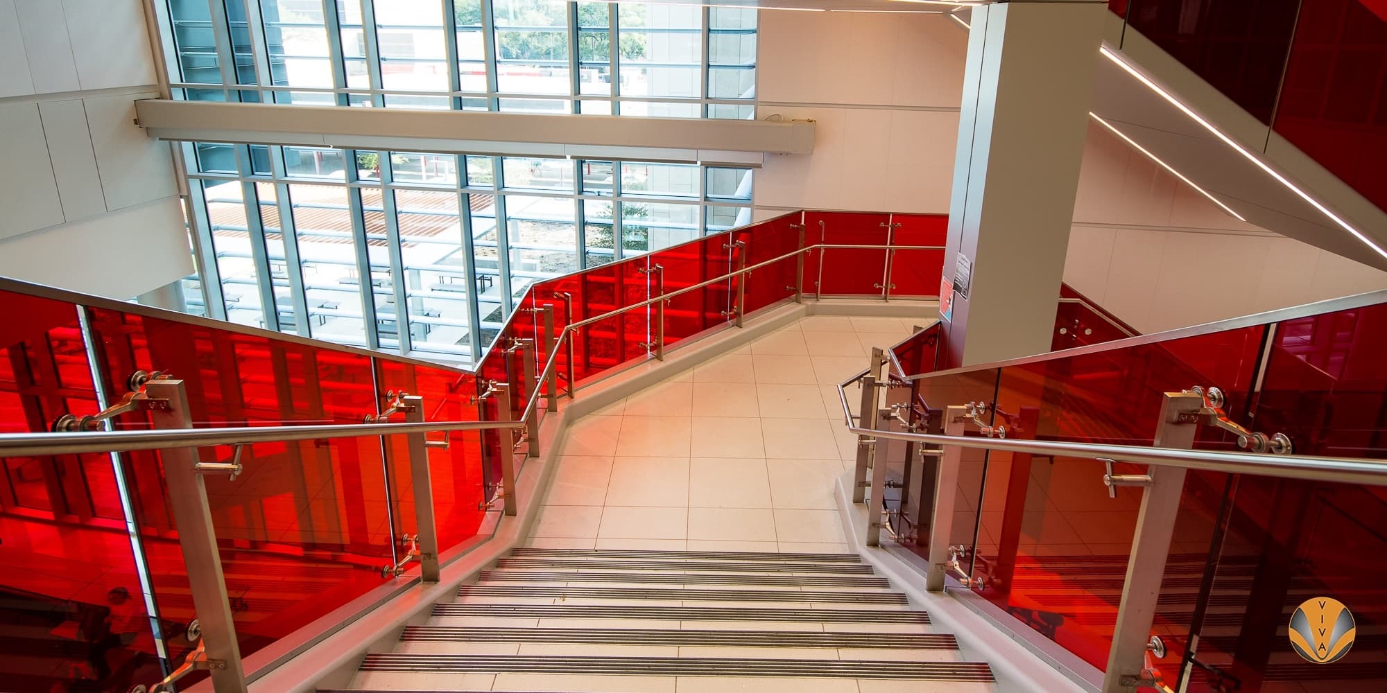 Monumental stair with custom designed and engineered stainless steel post railing system at SB-ISD near Houston, TX