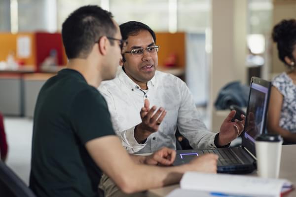 Men discussing open source project