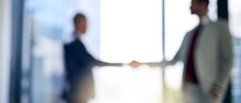 Blurred shot of two businessmen shaking hands in a 2022 12 15 00 14 57 utc