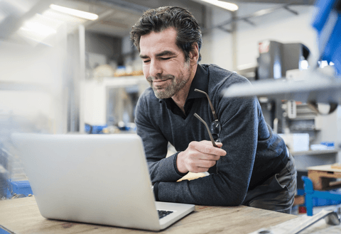 Businessman using laptop in a factory 2022 12 16 22 00 59 utc 1