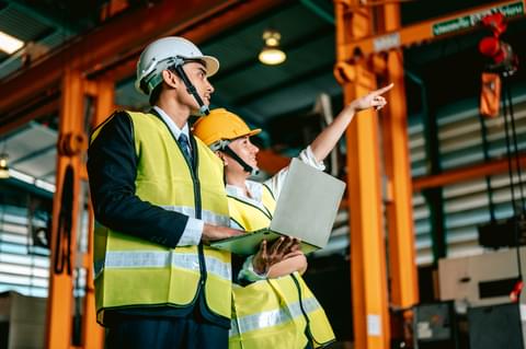 Factory manager and worker with safety helmet use 2022 08 29 18 23 29 utc