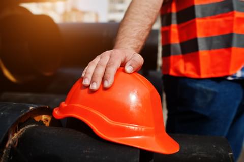 Hand of worker man in safety orange helmet near st 2022 06 06 19 09 02 utc
