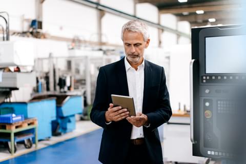 Manager using digital tablet in high tech company 2022 03 08 01 24 01 utc