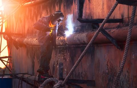 Welder on scaffold is welding the old rusty vessel 2022 11 04 23 28 34 utc