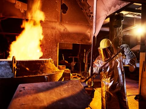 Worker holding metal rod in furnace at foundry 2022 11 06 22 51 38 utc