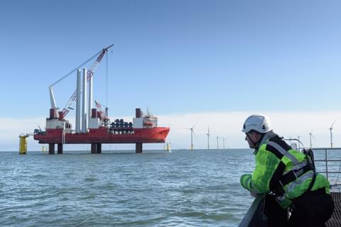 Worker looking at construction ship and offshore w 2022 01 14 17 16 26 utc