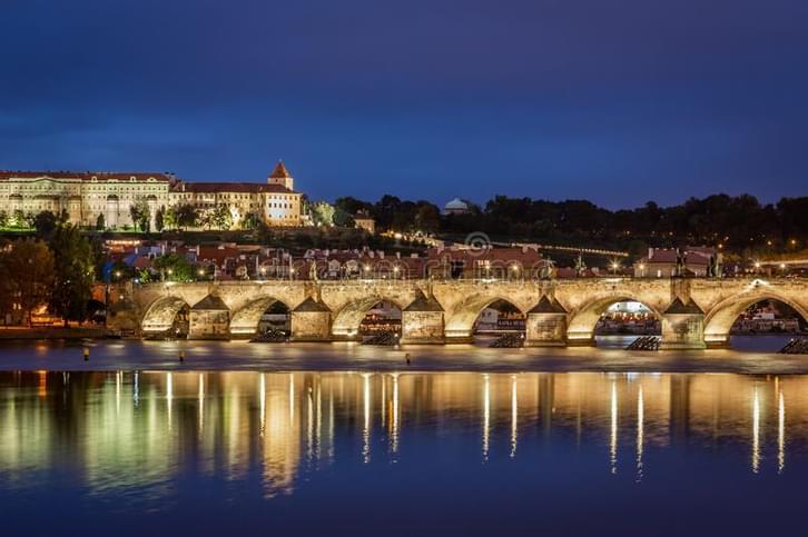 Beautiful night view water people illuminated charles bridge prague czech republic september castle 134368489