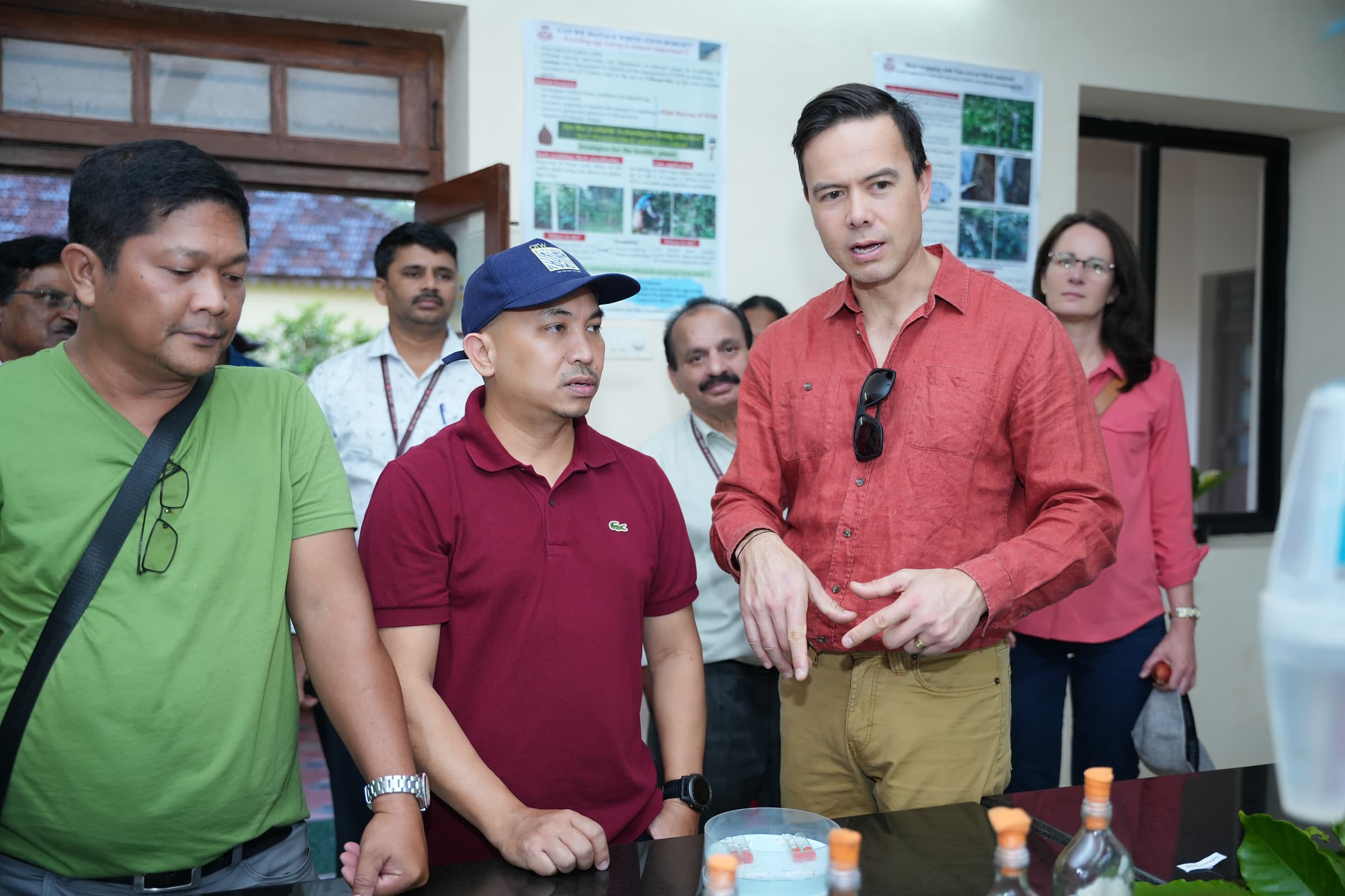 Jun Ramirez, Technical Advisor from ACDI/VOCA, Neil Franje, and Dr. Kraig Kraft, look at a display in the entomology lab at CCRI.