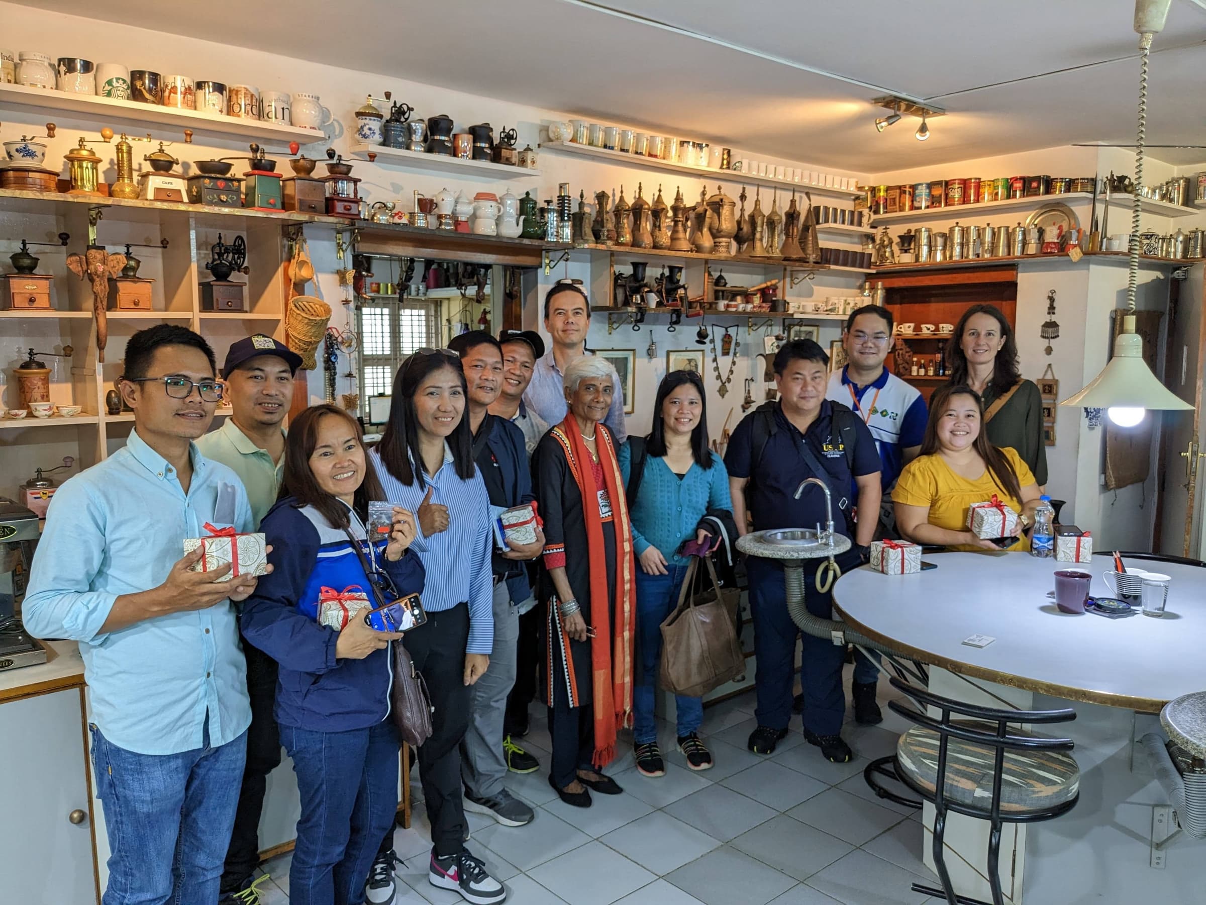 The entire group visits Ms. Sunalini Menon's quality lab (center of the group with long red scarf), which also serves as a small museum of coffee artifacts.